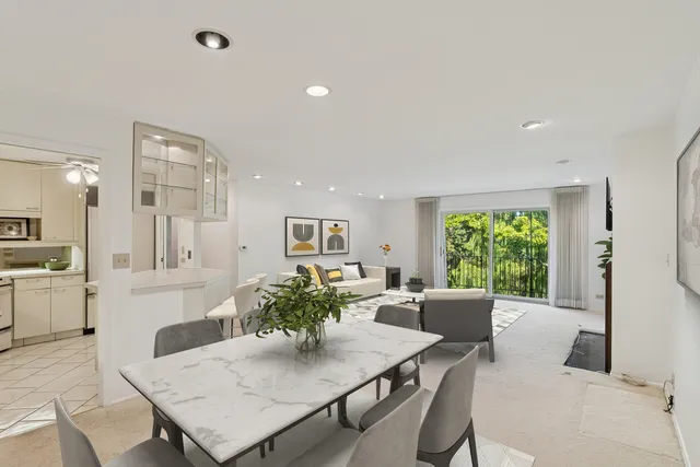 a view of a dining room with furniture and a large window