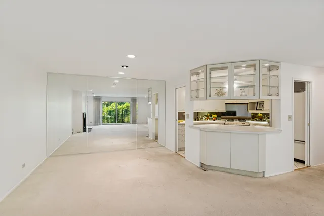 a view of kitchen with stainless steel appliances granite countertop a stove and a refrigerator