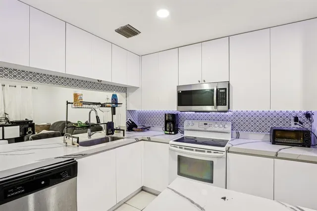 a kitchen with a sink stove and microwave