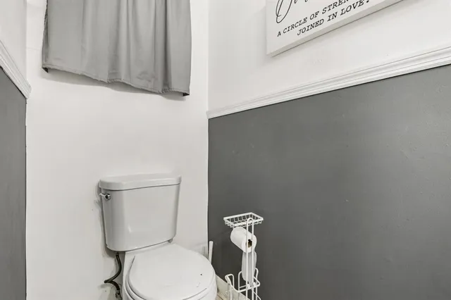 a white toilet sitting next to a sink