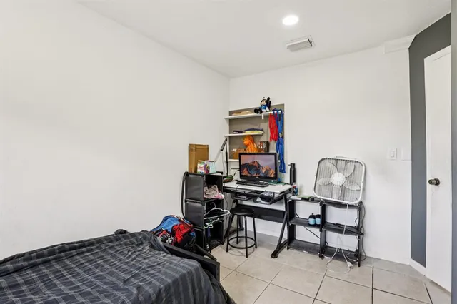 a bedroom with a bed and a desk