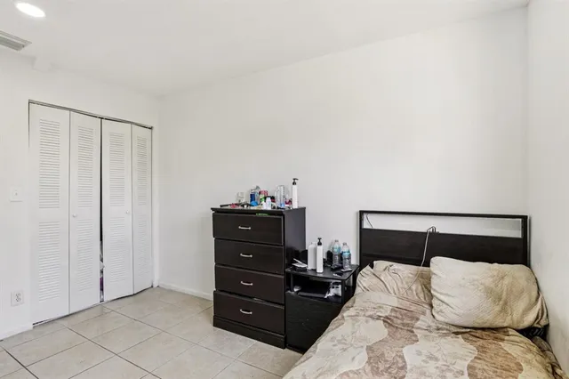 a bedroom with a bed and a mirror