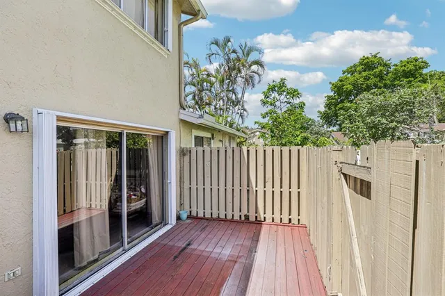 a view of a room with wooden floor and fence