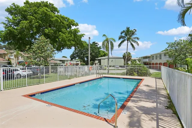 a view of swimming pool with a patio and a yard
