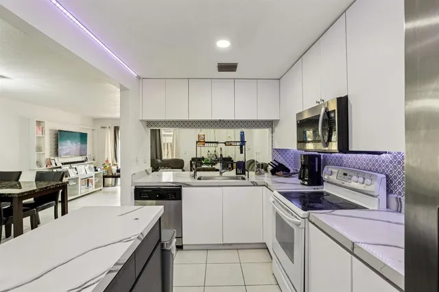a kitchen with a sink stove and cabinets