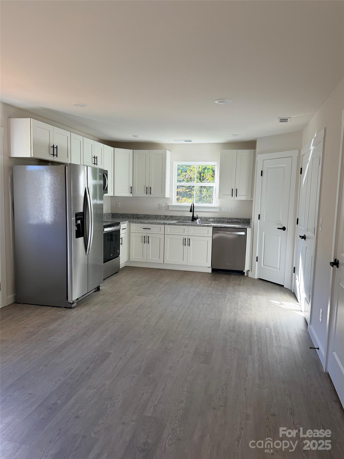407 15th Avenue Southwest Hickory, NC 28602 - Photo 2 of 10 a kitchen with stainless steel appliances a refrigerator and a stove