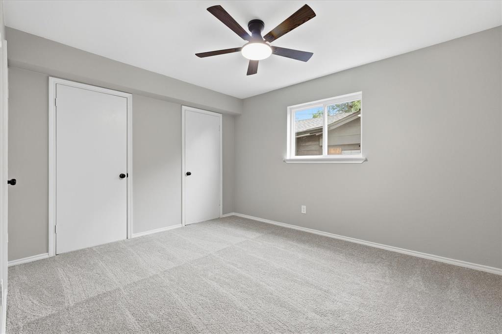857 Twilight Trail Grapevine, TX 76051 - Photo 25 of 35 Spacious room featuring light gray wall paint, light-toned carpet flooring, a window with exterior views, and a ceiling fan with integrated lighting