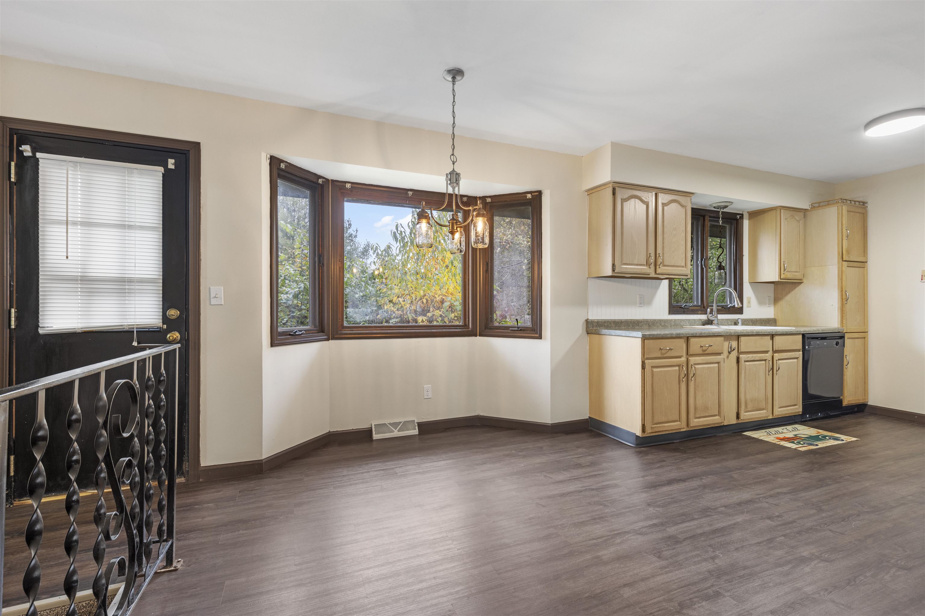 3428 Springwheat Street Rockford, IL 61114 - Photo 11 of 21 a kitchen with kitchen island granite countertop a stove a sink and a wooden floors