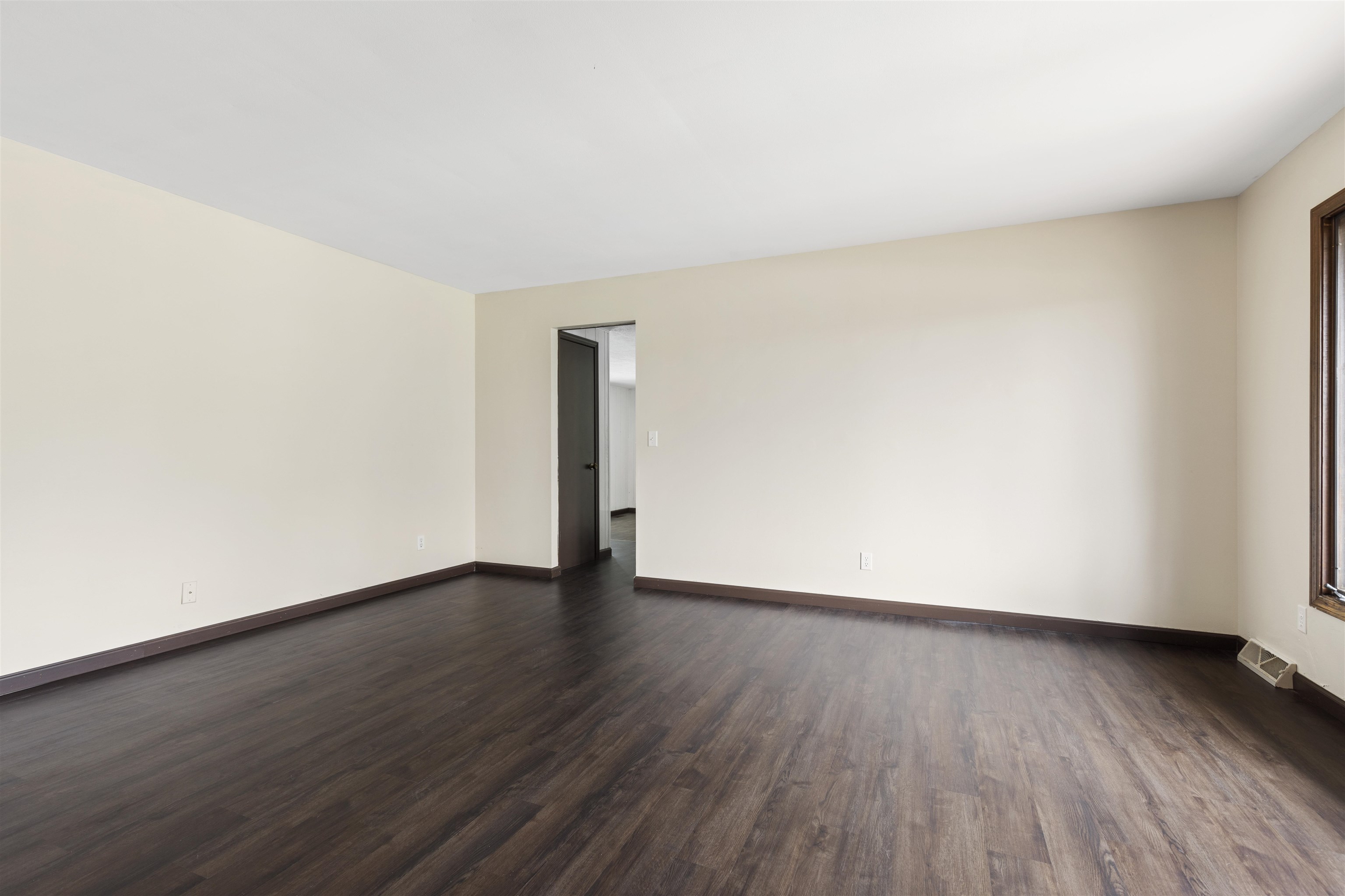 3428 Springwheat Street Rockford, IL 61114 - Photo 4 of 21 an empty room with wooden floor