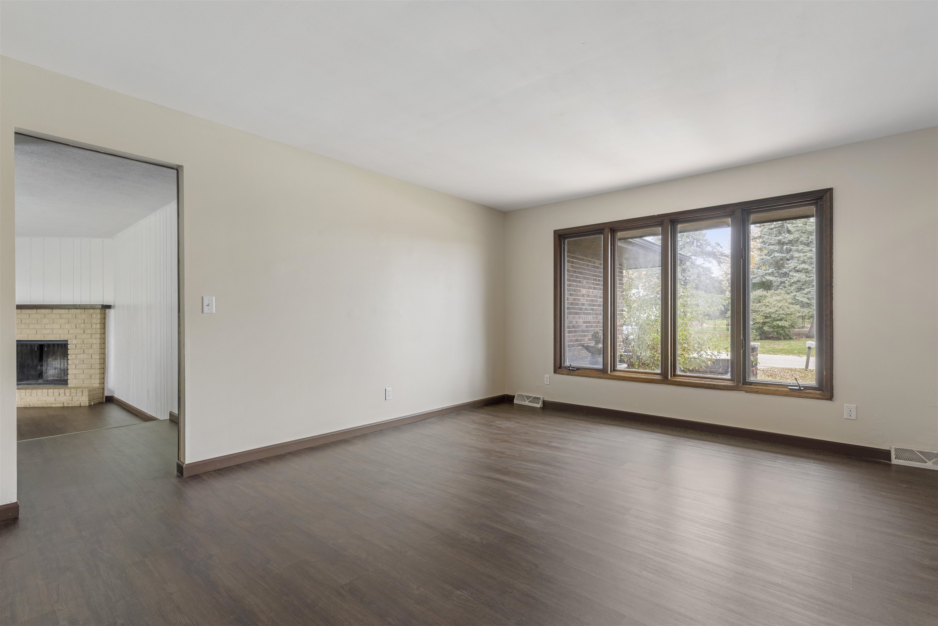 3428 Springwheat Street Rockford, IL 61114 - Photo 5 of 21 an empty room with wooden floor and windows