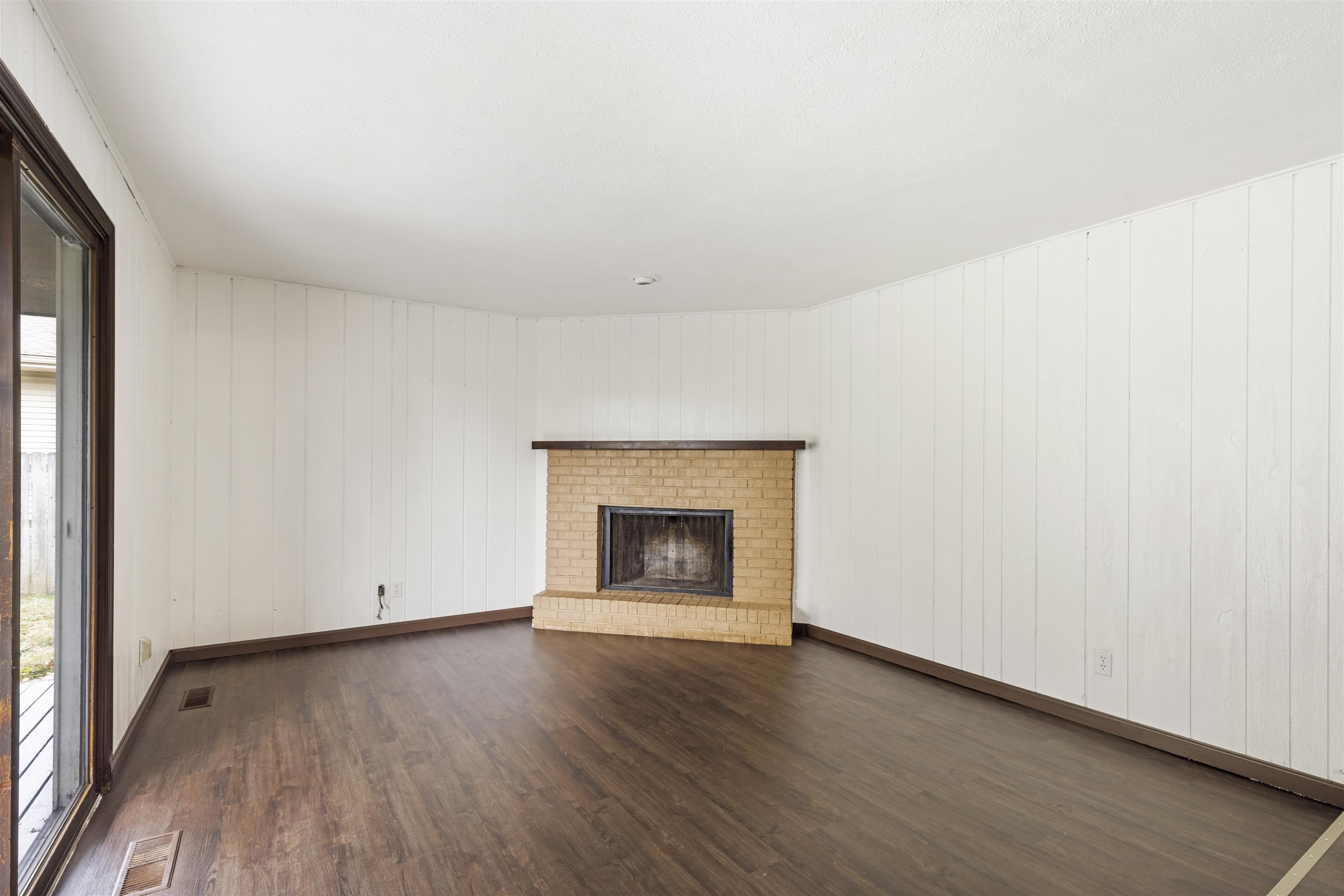 3428 Springwheat Street Rockford, IL 61114 - Photo 7 of 21 an empty room with wooden floor and fireplace