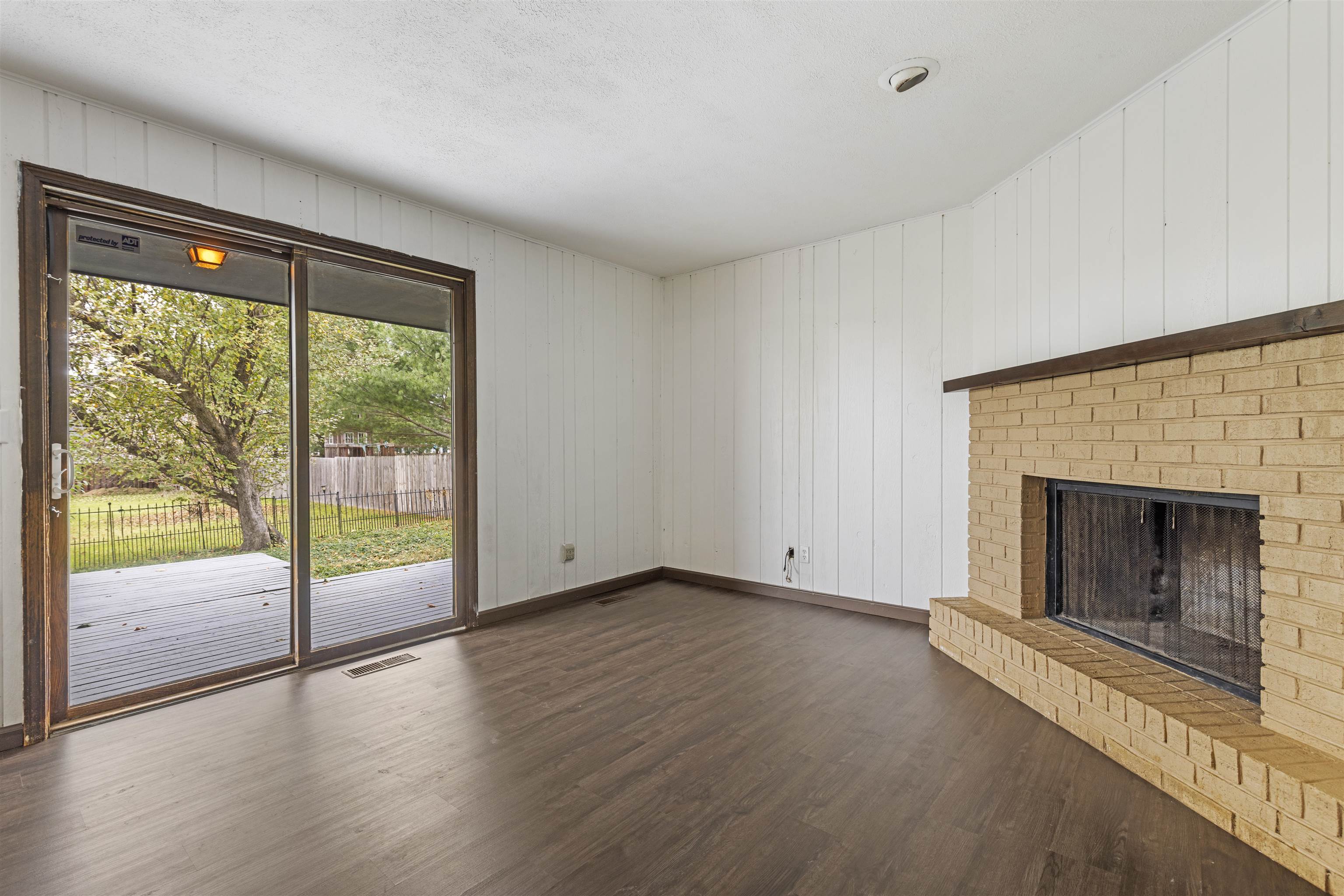 3428 Springwheat Street Rockford, IL 61114 - Photo 8 of 21 an empty room with wooden floor fireplace and windows