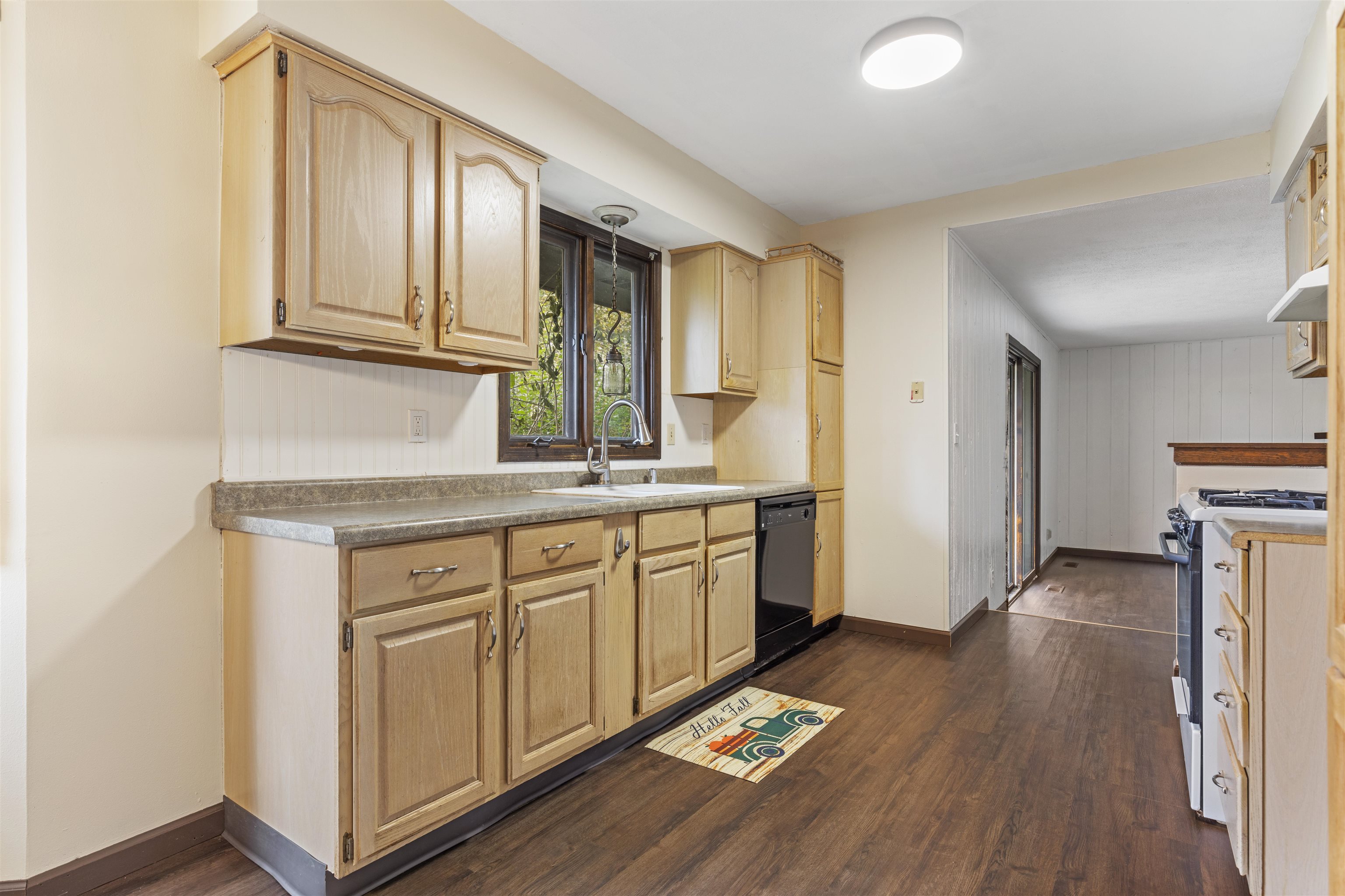 3428 Springwheat Street Rockford, IL 61114 - Photo 10 of 21 a kitchen with granite countertop a stove a sink and a refrigerator with wooden floors