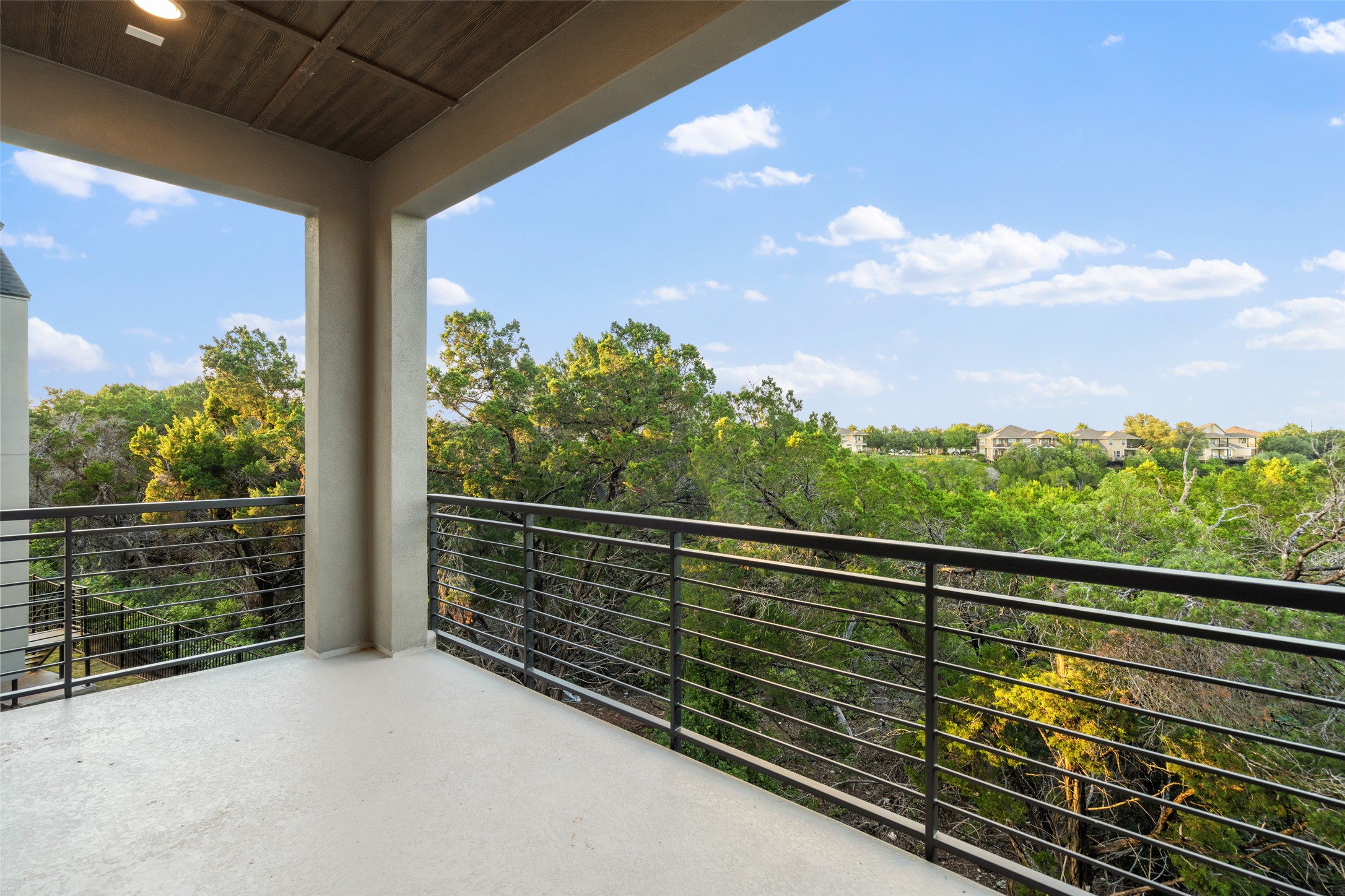 9803 Ribelin Ranch Court, Unit 19 Austin, TX 78750 - Photo 13 of 14 A private balcony offers verdant vistas and distant neighborhood views.