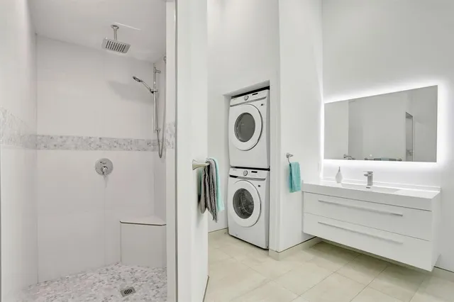 a living room with lots of furniture and a potted plant