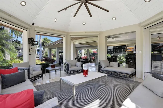 a living room with furniture a rug and a chandelier