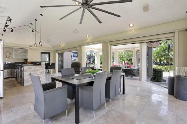 a view of a kitchen with furniture and refrigerator