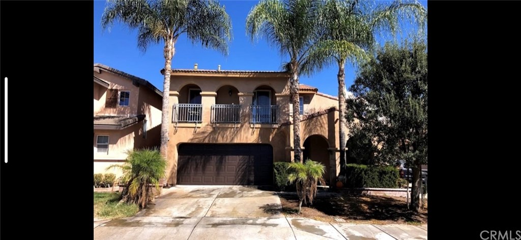 1474 Albillo Loop Perris, CA 92571 - Photo 1 of 1 Front of Home - Driveway and beautiful Plan trees