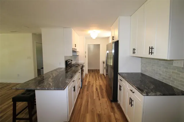 a kitchen with a sink and refrigerator