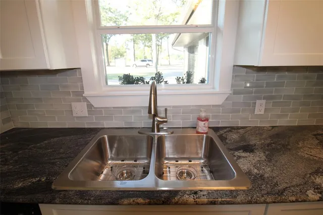 a kitchen with a sink and a window