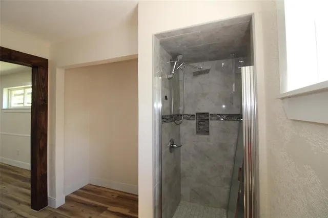 a bathroom with a glass shower door