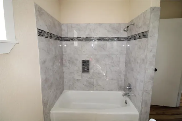 a bathroom with a bathtub and a shower