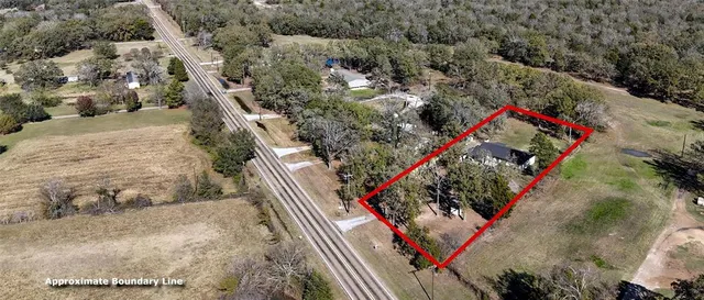 an aerial view of a house with an outdoor space