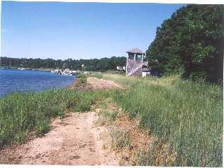 Undisclosed Address Marstons Mills, MA 02648 - Photo 2 of 4 a view of a lake with a city