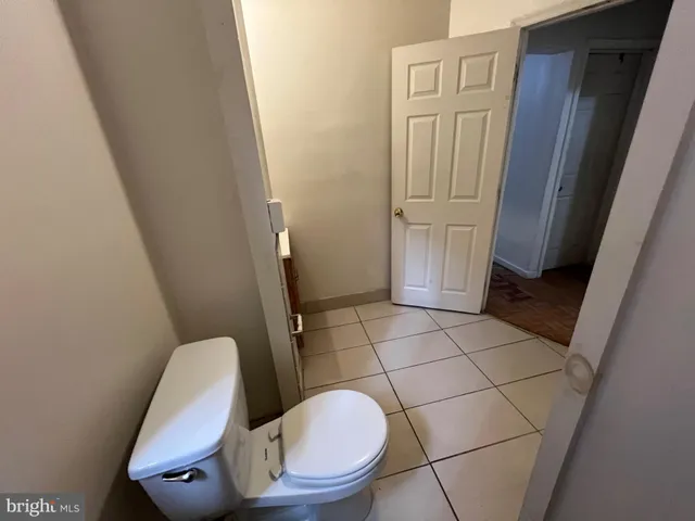 a bathroom with a toilet and a mirror