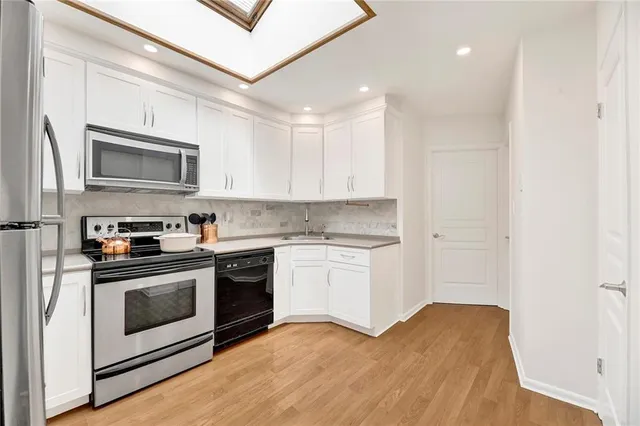 a kitchen with stainless steel appliances granite countertop a stove and a microwave