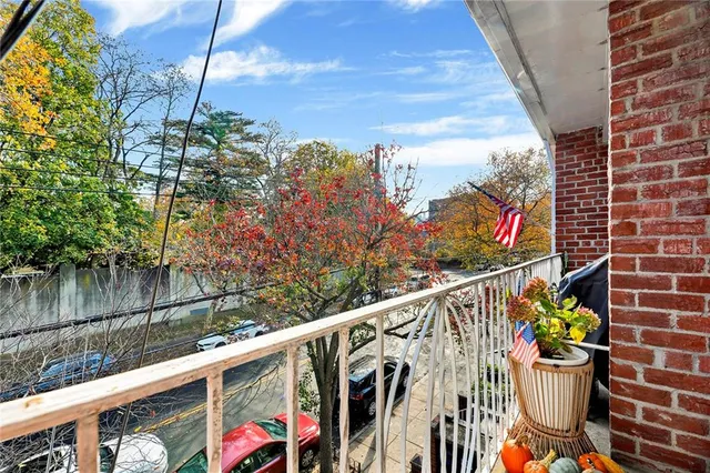 a view of a balcony with wooden fence and potted plants