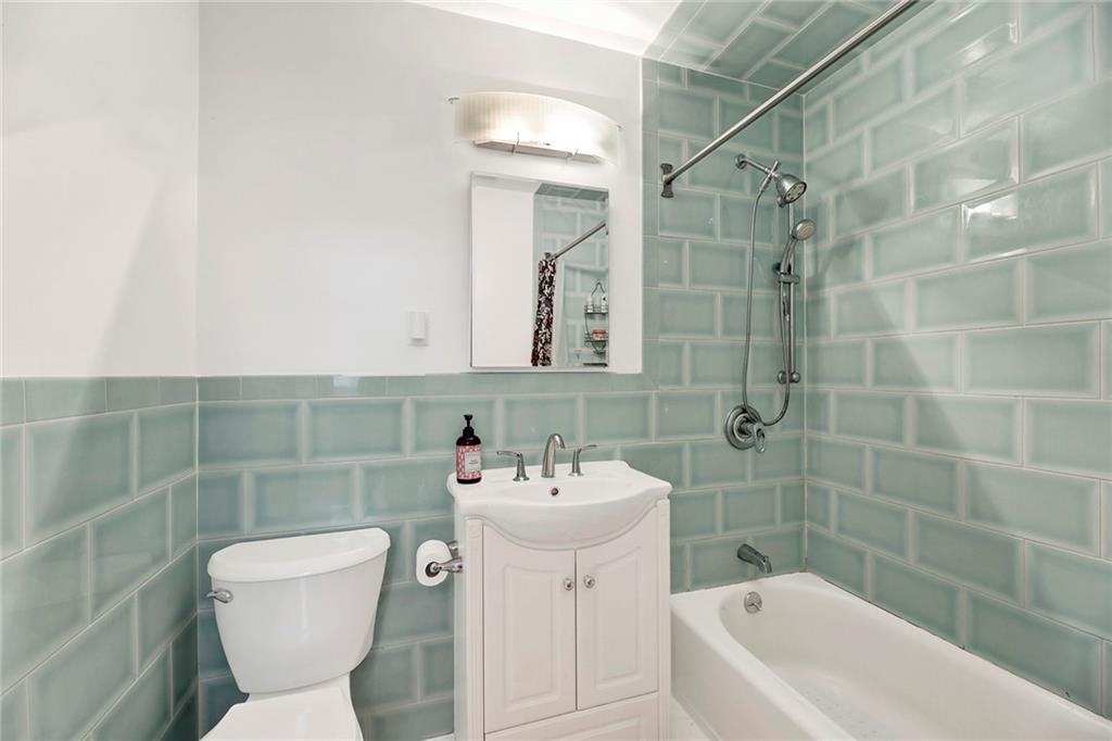 8940 Colonial Road, Unit 3 Brooklyn, NY 11209 - Photo 16 of 21 a bathroom with a sink mirror toilet and bathtub