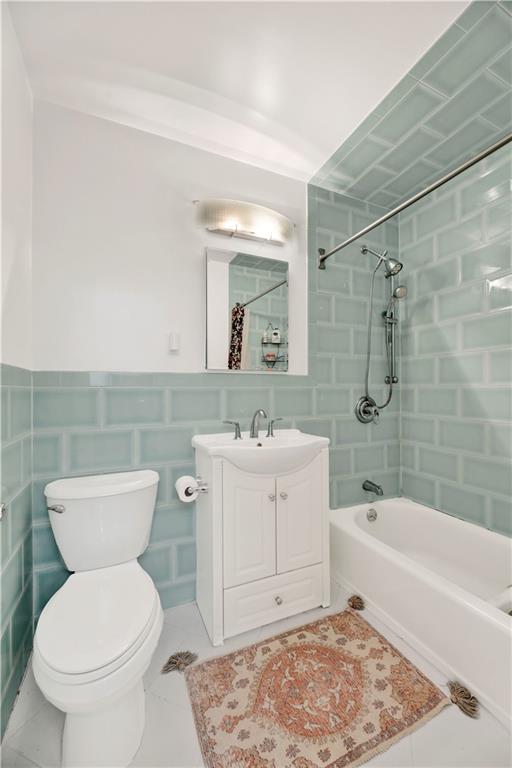 8940 Colonial Road, Unit 3 Brooklyn, NY 11209 - Photo 17 of 21 a bathroom with a toilet sink and mirror