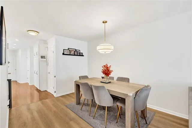 a view of a dining room with furniture and wooden floor