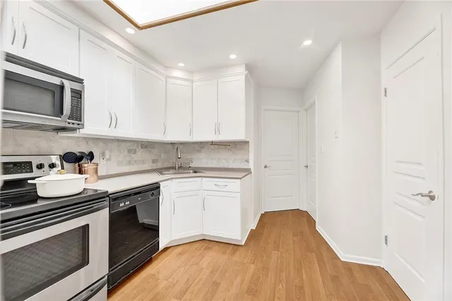 a kitchen with stainless steel appliances granite countertop a sink and a stove