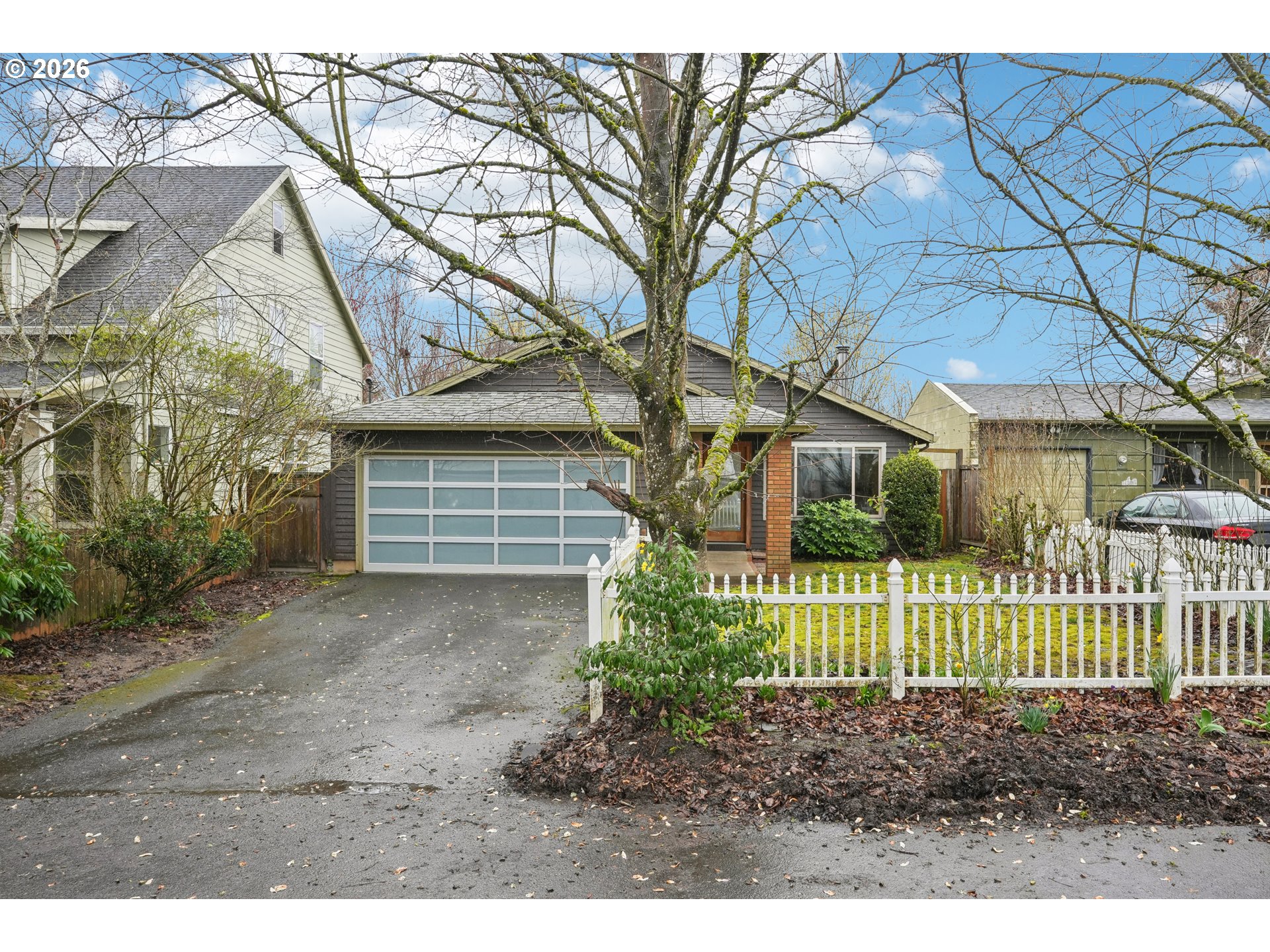 4133 Southeast Tibbetts Street Portland, OR 97202 - Photo 1 of 35 a front view of a house with a yard and plants