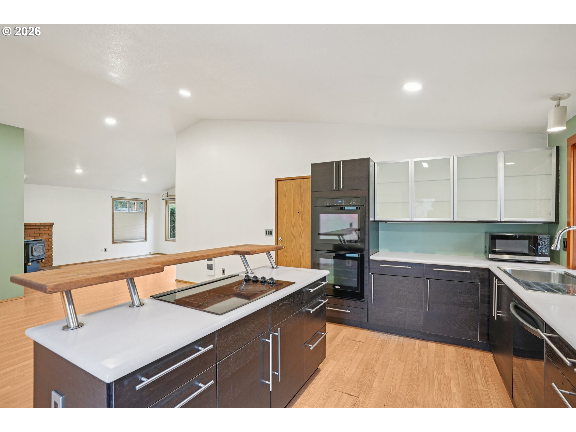4133 Southeast Tibbetts Street Portland, OR 97202 - Photo 12 of 35 a kitchen with a sink counter top space and stainless steel appliances