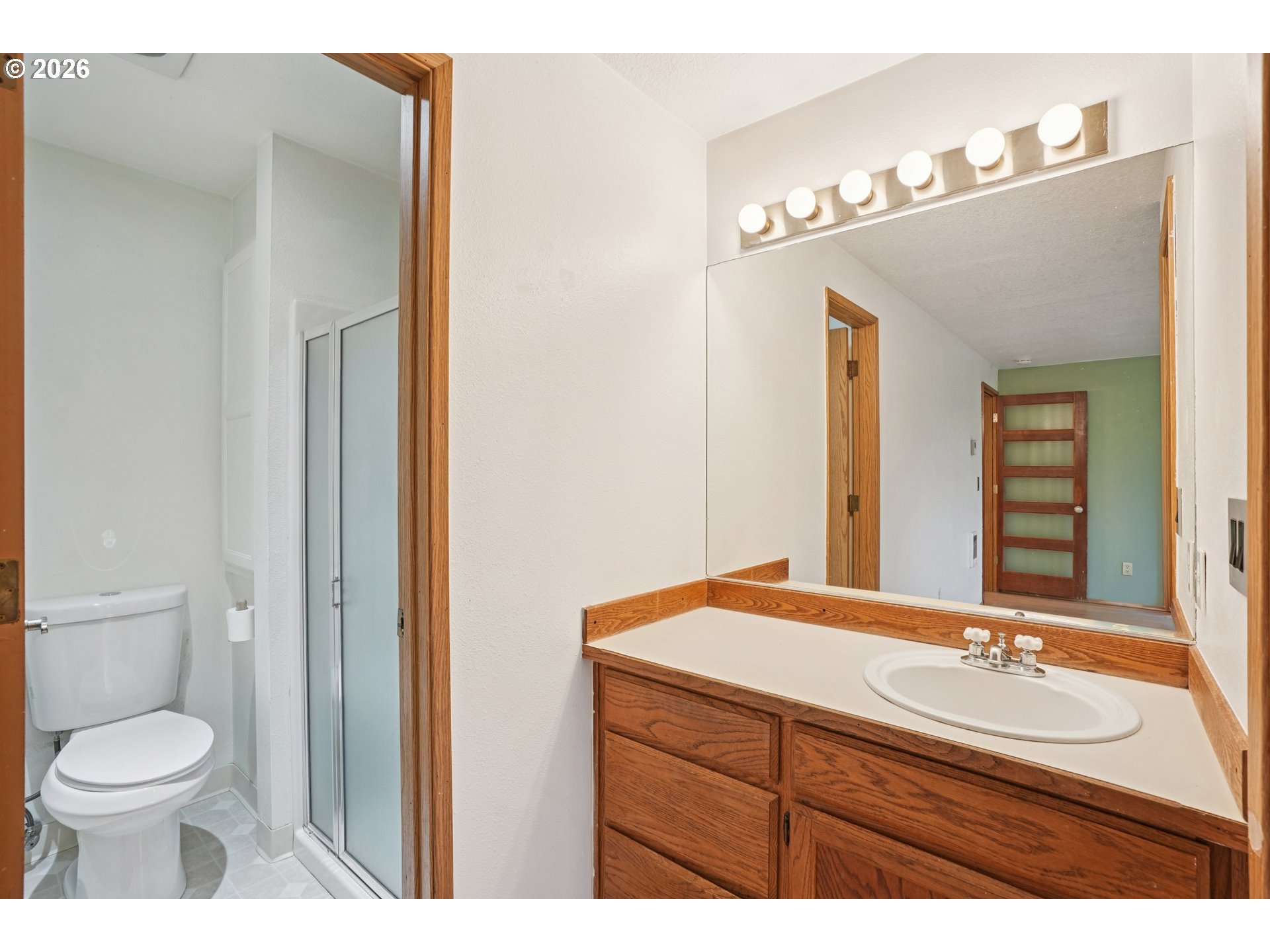 4133 Southeast Tibbetts Street Portland, OR 97202 - Photo 18 of 35 a bathroom with a sink a toilet and a mirror