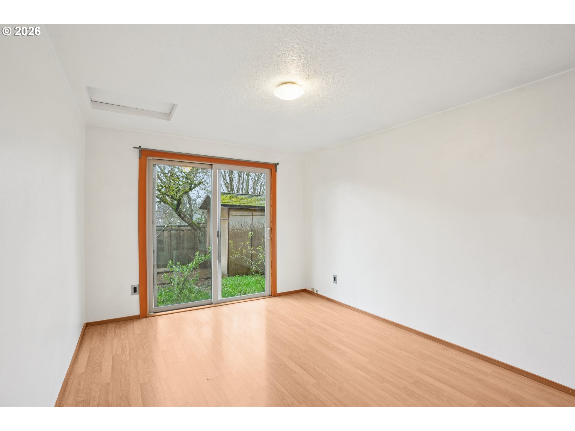 4133 Southeast Tibbetts Street Portland, OR 97202 - Photo 21 of 35 a view of an empty room with wooden floor and a window