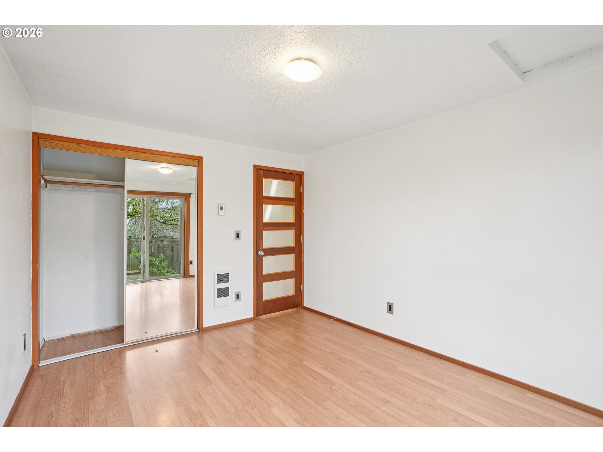 4133 Southeast Tibbetts Street Portland, OR 97202 - Photo 23 of 35 a view of an empty room with window and wooden floor
