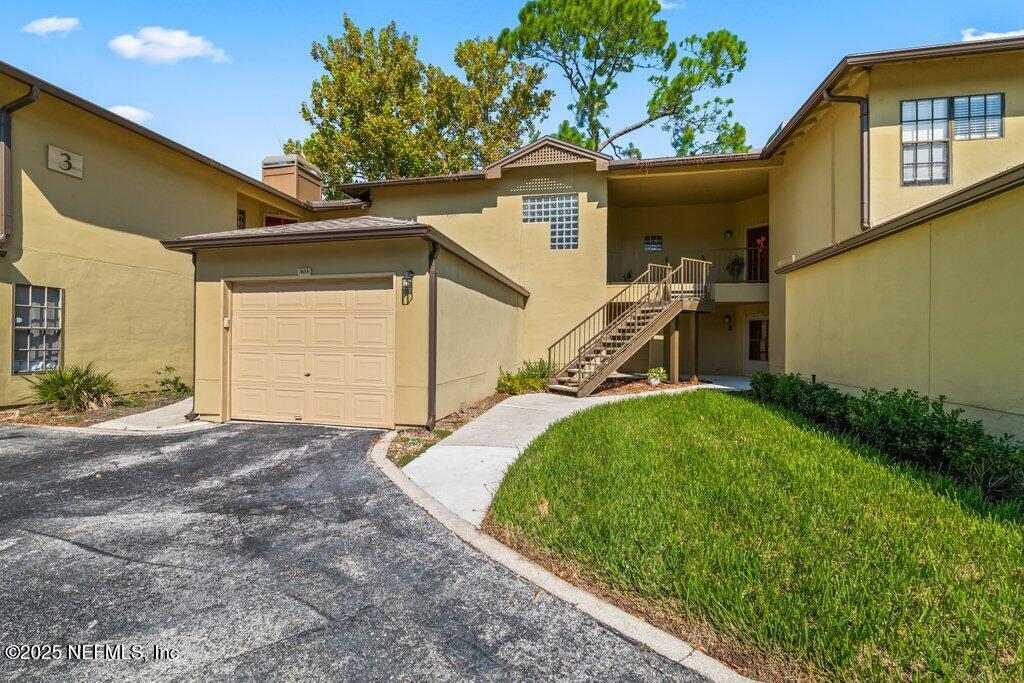 10150 Belle Rive Boulevard, Unit 303 Jacksonville, FL 32256 - Photo 17 of 23 a view of a house with a patio