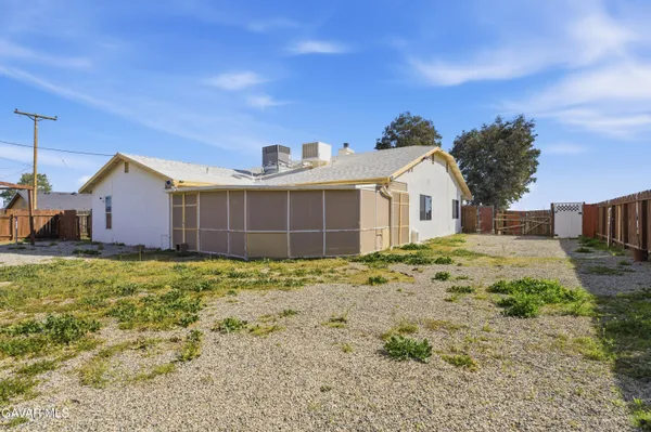 a view of a house with a backyard