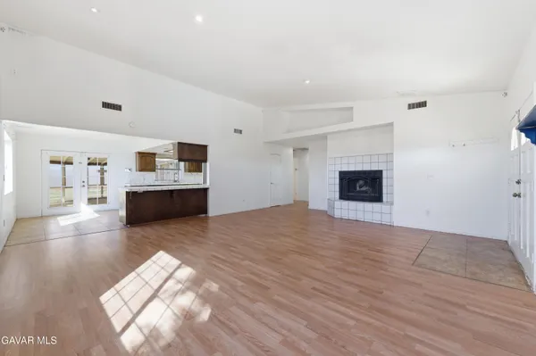 a view of open kitchen with sink and cabinets