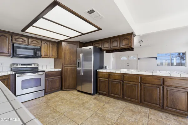 a kitchen with granite countertop a sink and stainless steel appliances