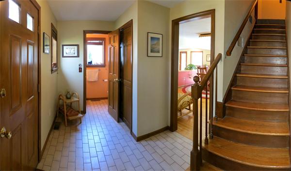 307 Shutesbury Road Amherst, MA 01002 - Photo 9 of 30 a view of a hallway with wooden floor and entryway with a living room
