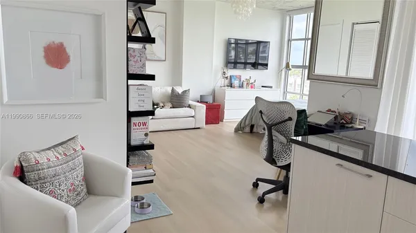 a living room with furniture and a potted plant