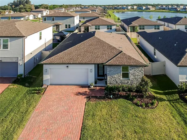 a aerial view of a house with yard patio and swimming pool