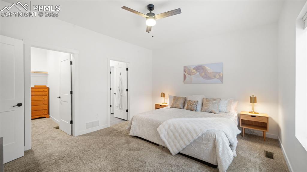 13455 Ravine Drive West Colorado Springs, CO 80908 - Photo 13 of 32 a bedroom with a bed and a chandelier