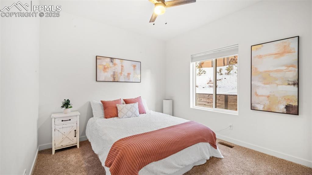 13455 Ravine Drive West Colorado Springs, CO 80908 - Photo 17 of 32 a bedroom with a large bed and a window