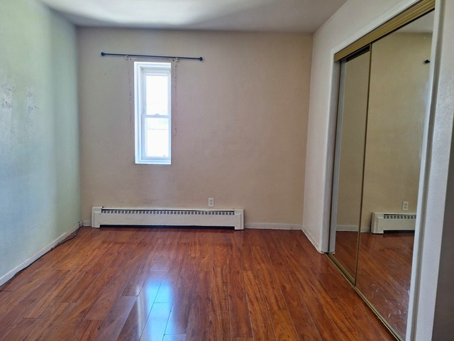 506 Main Street, Unit 2 Marseilles, IL 61341 - Photo 7 of 9 an empty room with wooden floor and windows
